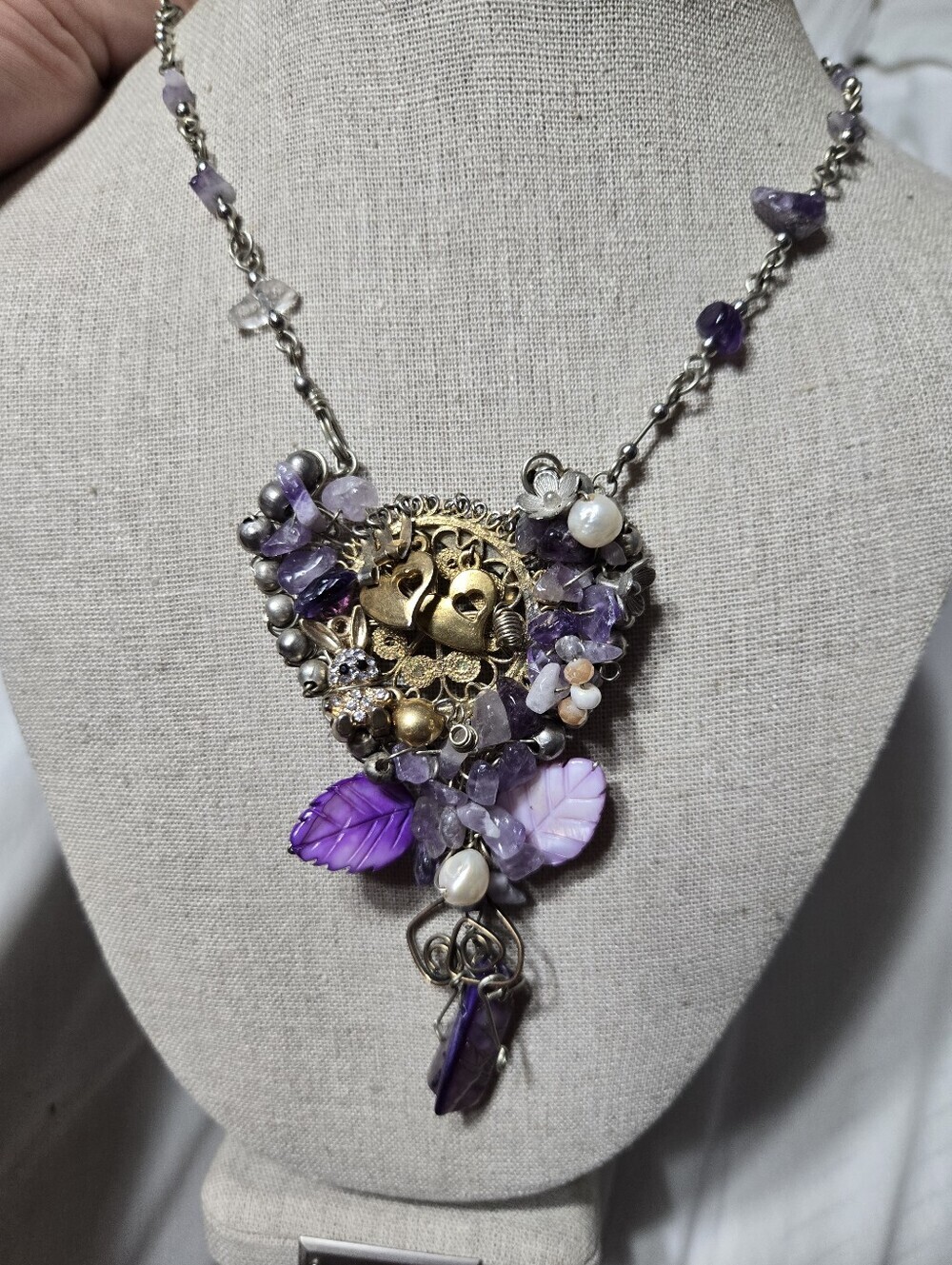 Handmade statement necklace features an ornate centerpiece Heart Shaped Purple